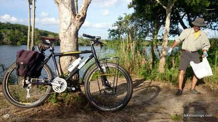 Picture of bike commuter picking up trash litter