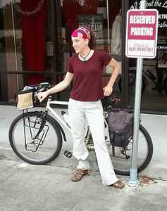 Picture of woman posing with her touring bike with handlebar basket